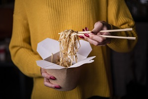 High angle woman holding box noodles